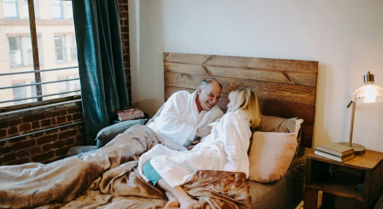 man in white dress shirt lying on bed